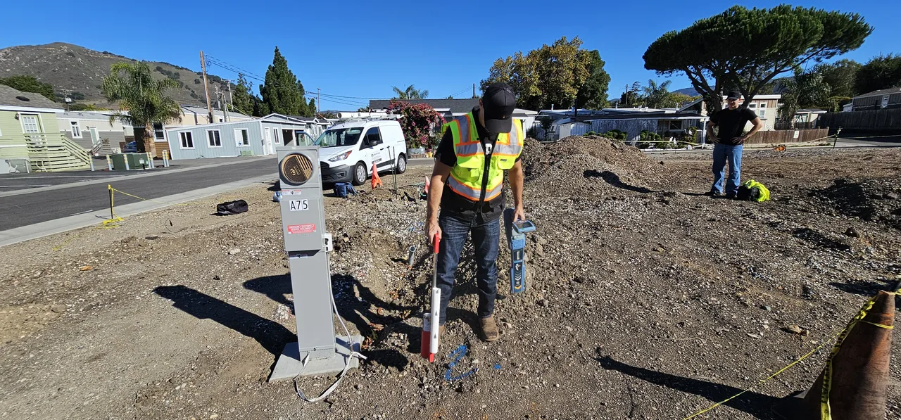 Coast Utility Locating pinpointing and marking a buried utility line near an electrical service in SLO County
